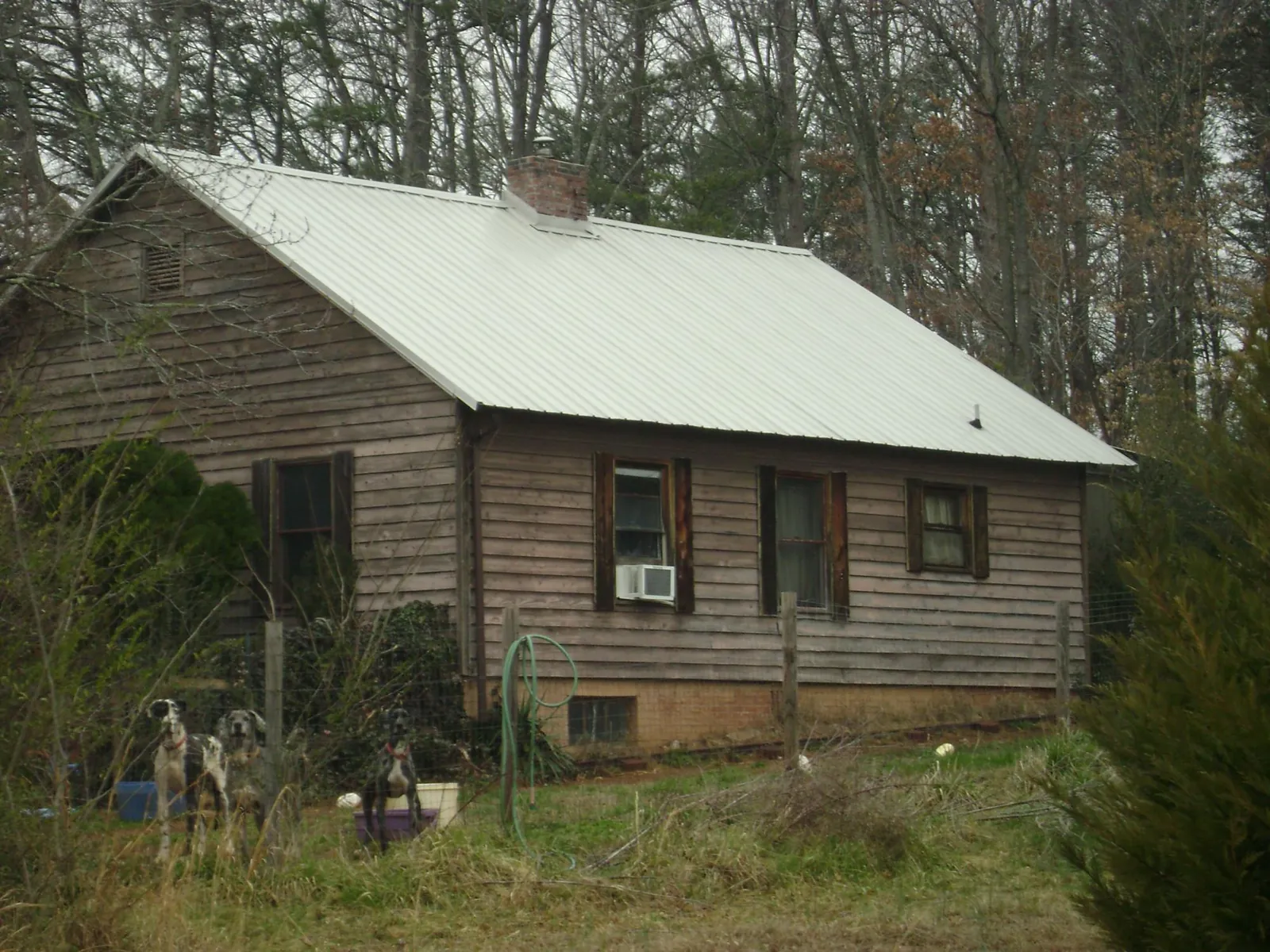 White metal roof on an old wood sided farmhouse, from a Metal Roof Installation job in South Whitley